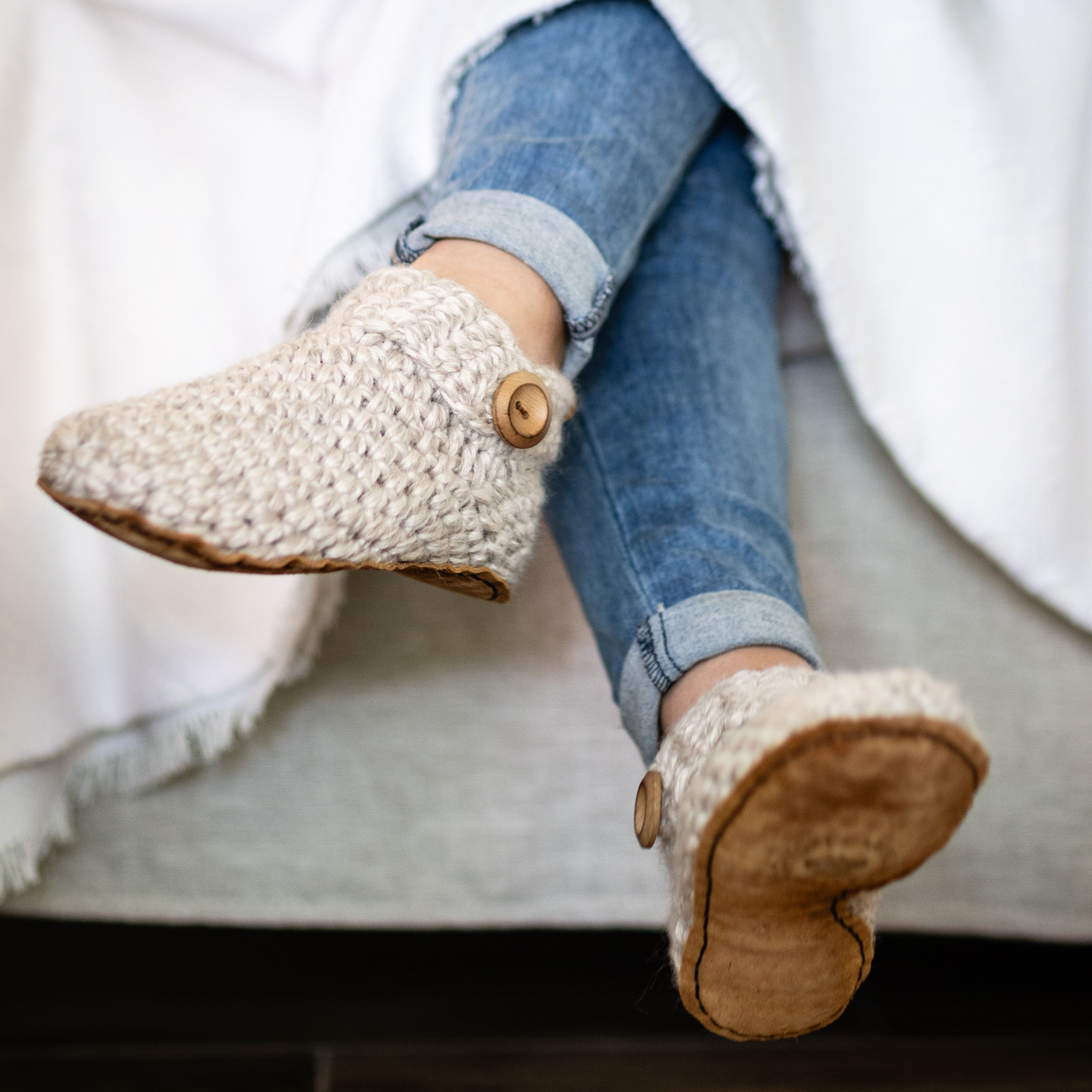 Chai Ankle Bootie slippers under white duvet