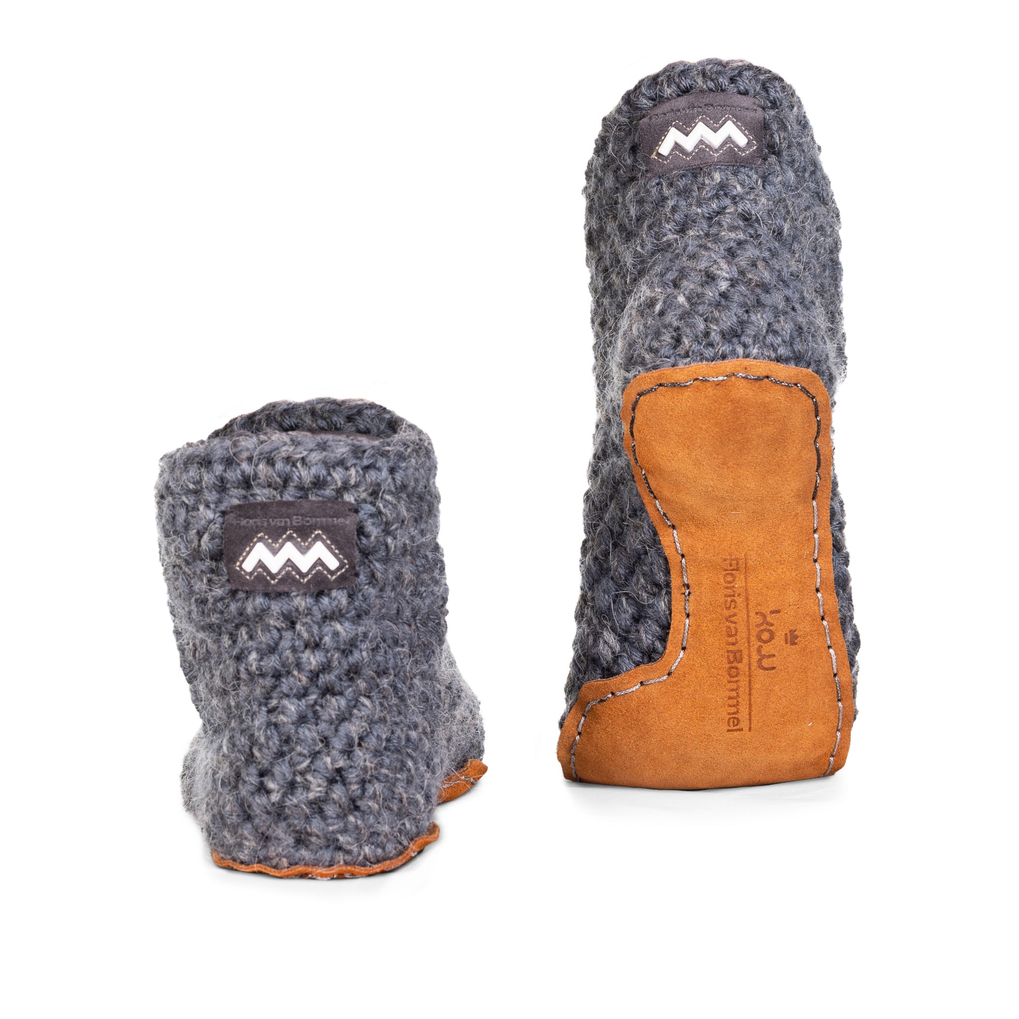 Floris x KOW slippers. A pair of charcoal grey knit slippers with leather soles on a white background. Back view.