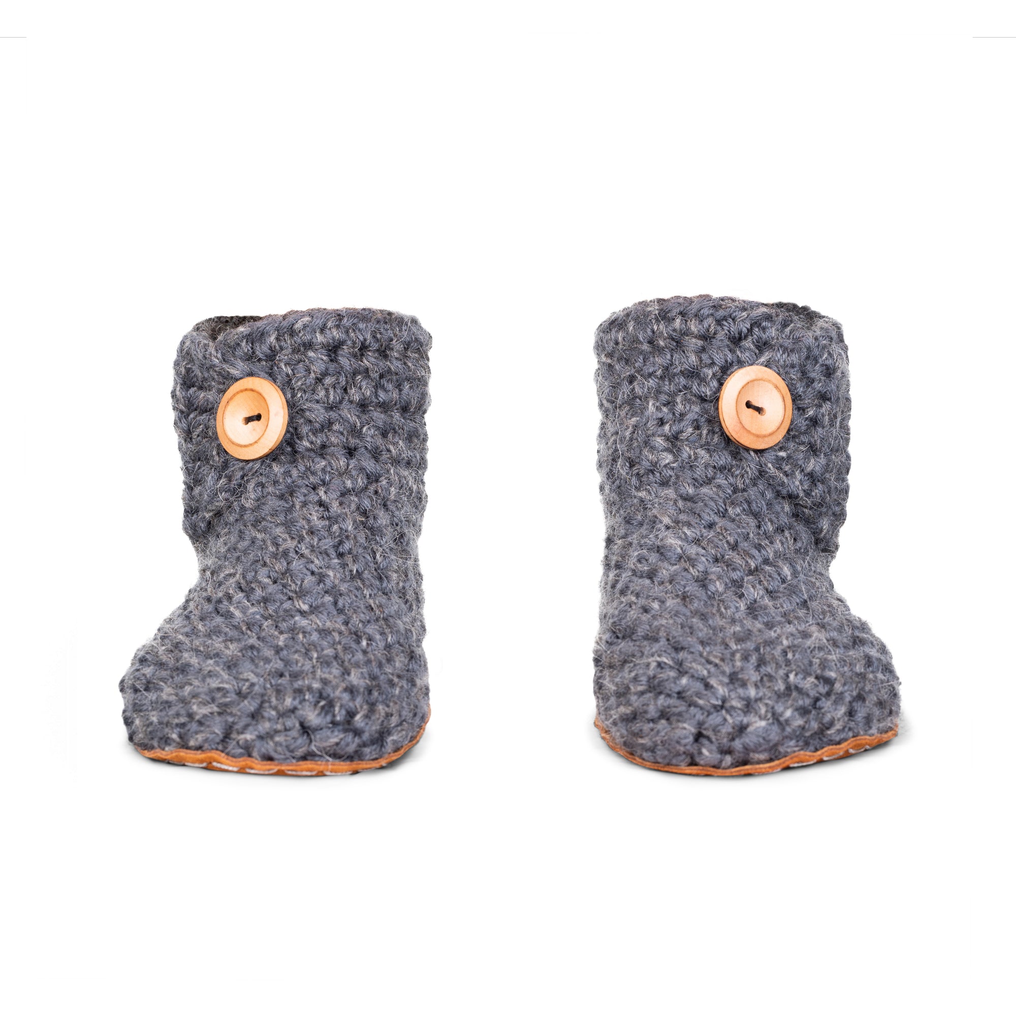Pair of Floris x KOW gray crocheted slippers with wooden buttons on a white background. Front view