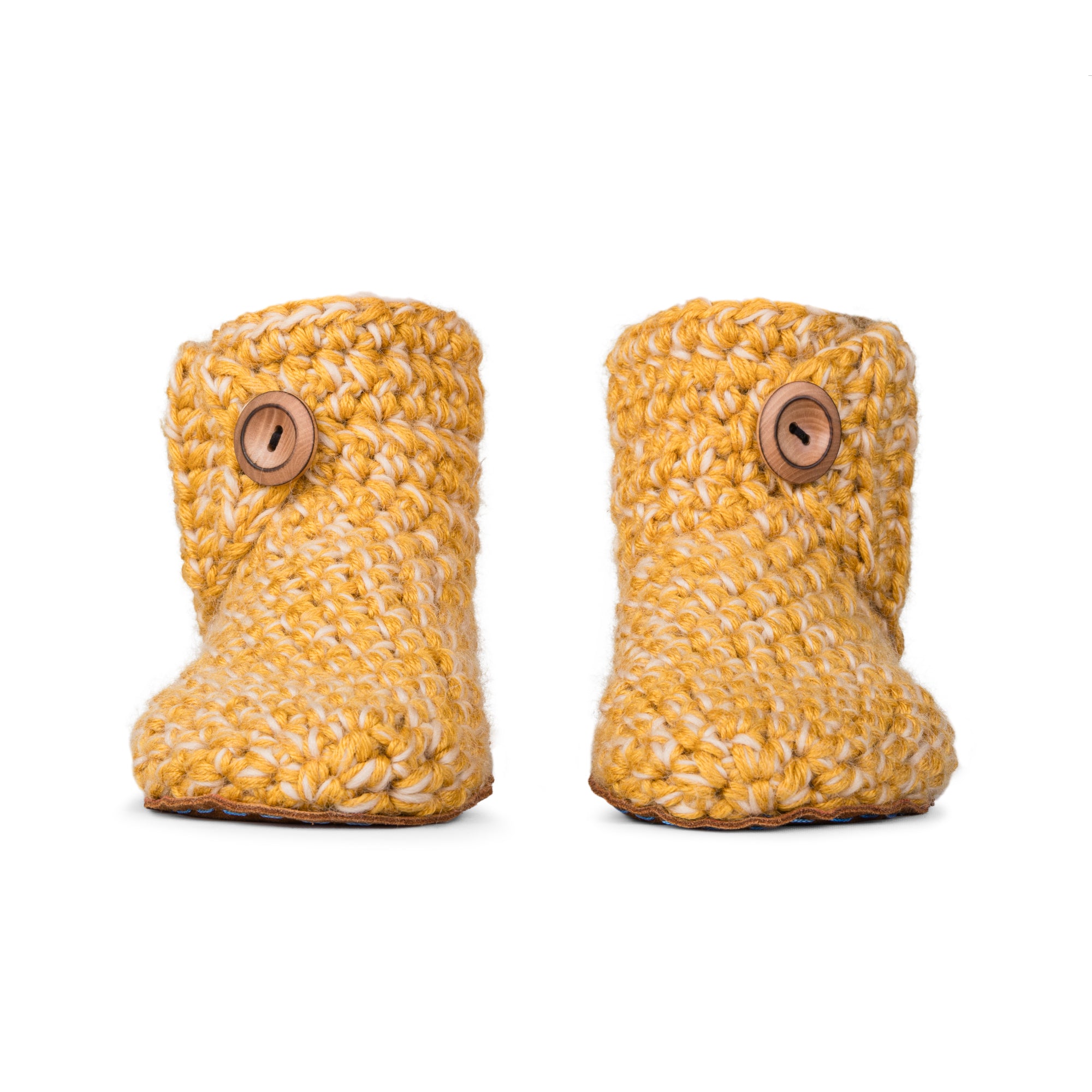Floris x KOW slippers. A pair of Butterscotch yellow knit slippers with leather soles on a white background. Front view
