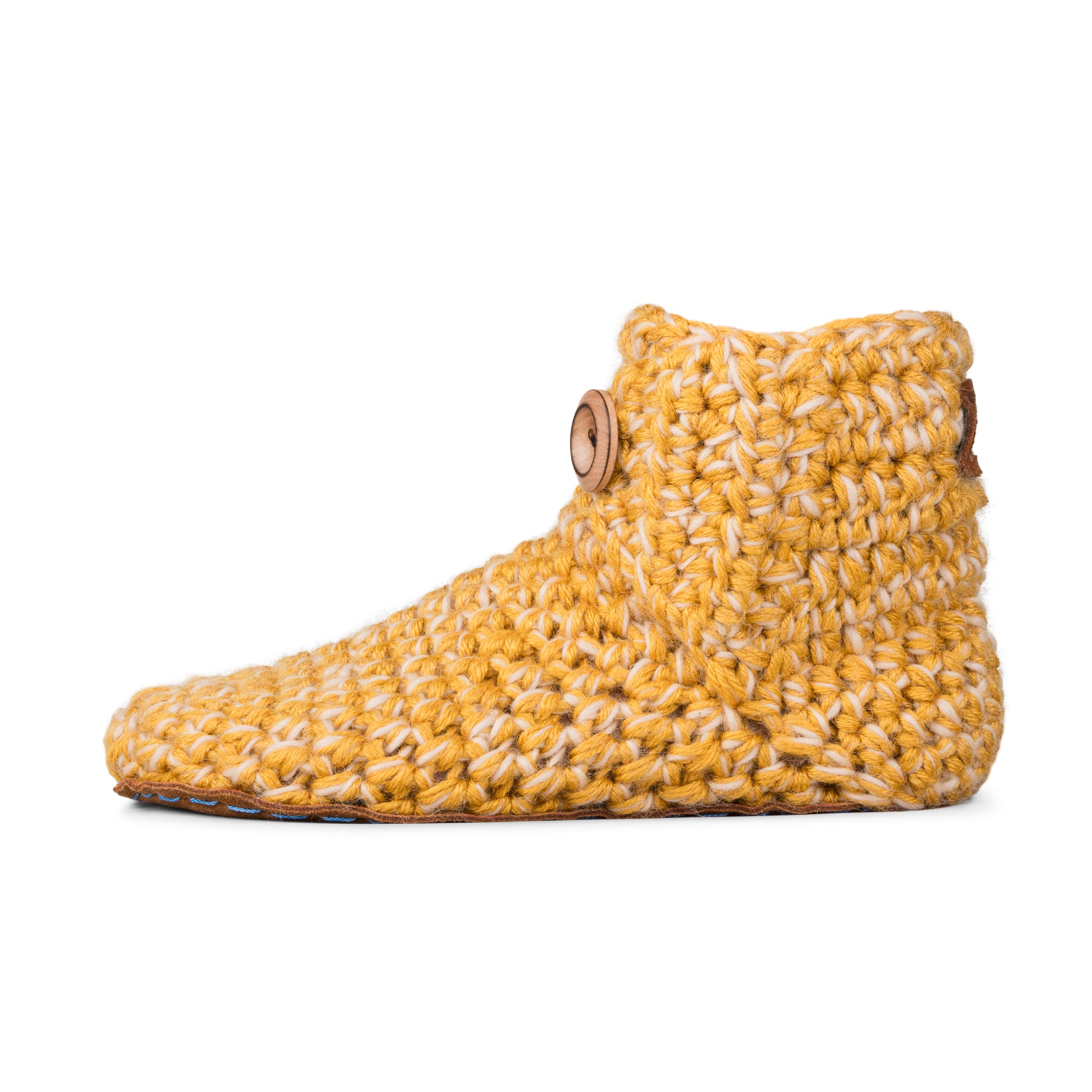 Floris x KOW slippers. A pair of Butterscotch yellow knit slippers with leather soles on a white background. Side view