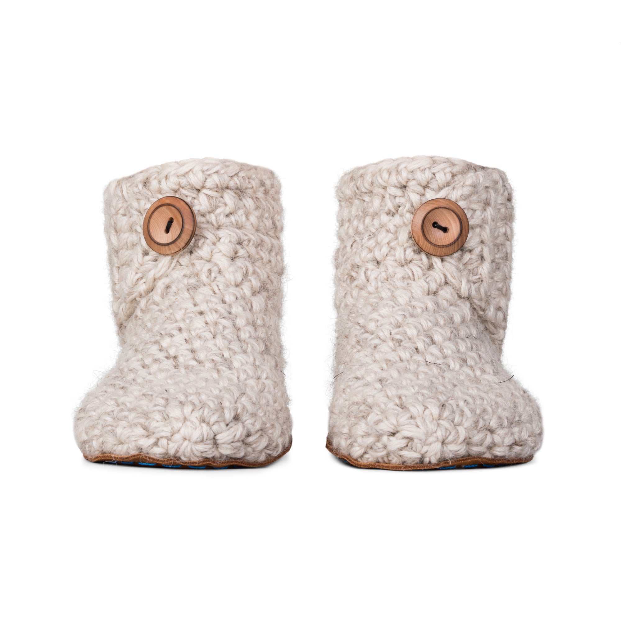Floris x KOW slippers. A pair of chai beige crocheted slippers with leather soles on a white background. Front view.