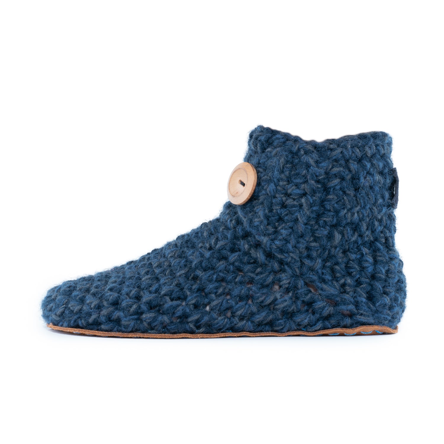 Floris x KOW slippers. A pair of midnight blue crocheted slippers with leather soles on a white background. Side view.
