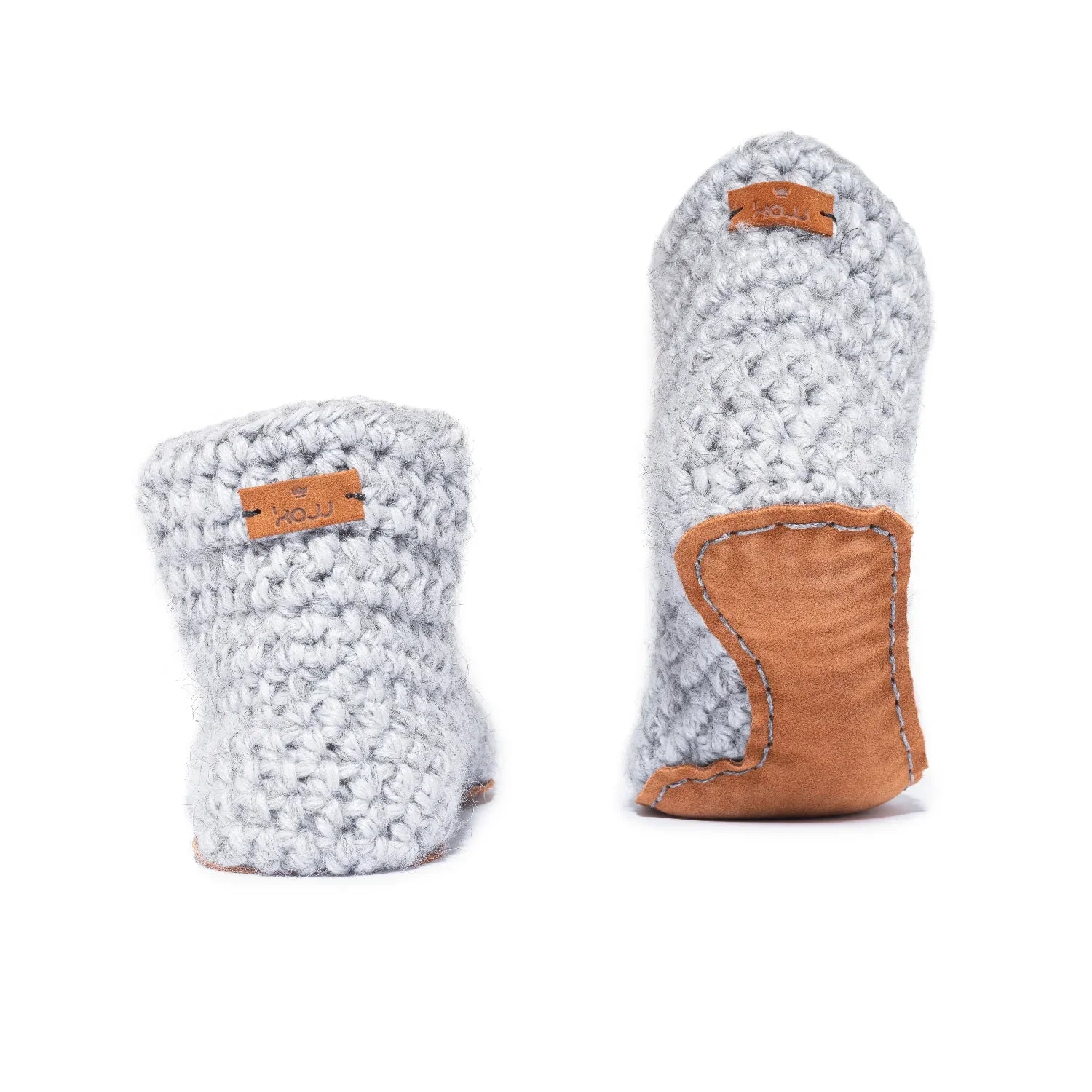 Pair of crocheted booties with leather soles on a white background