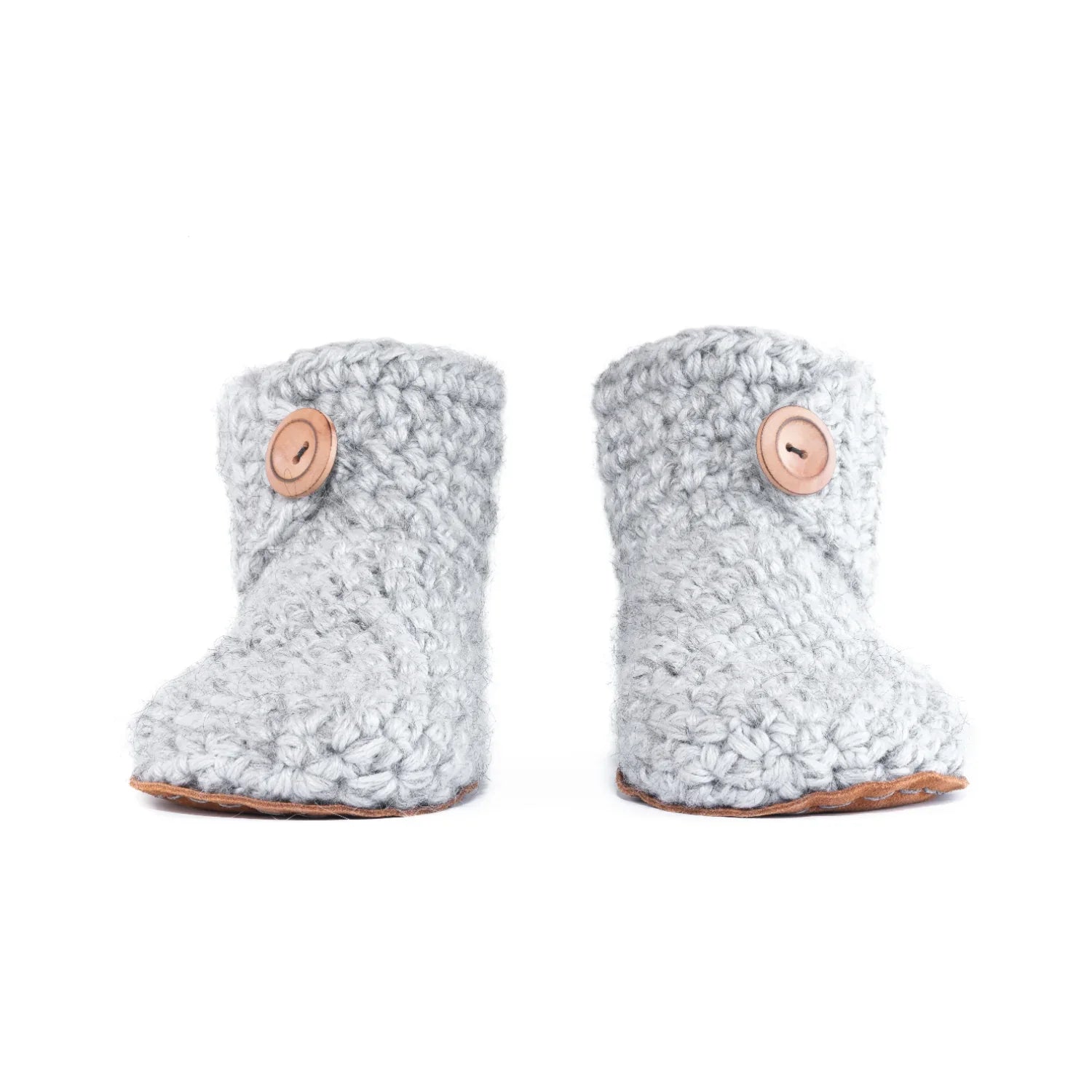 Pair of gray knitted booties with wooden buttons on a white background