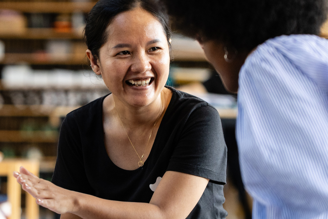 Smiling Employee Serving a Customer in the Workshop