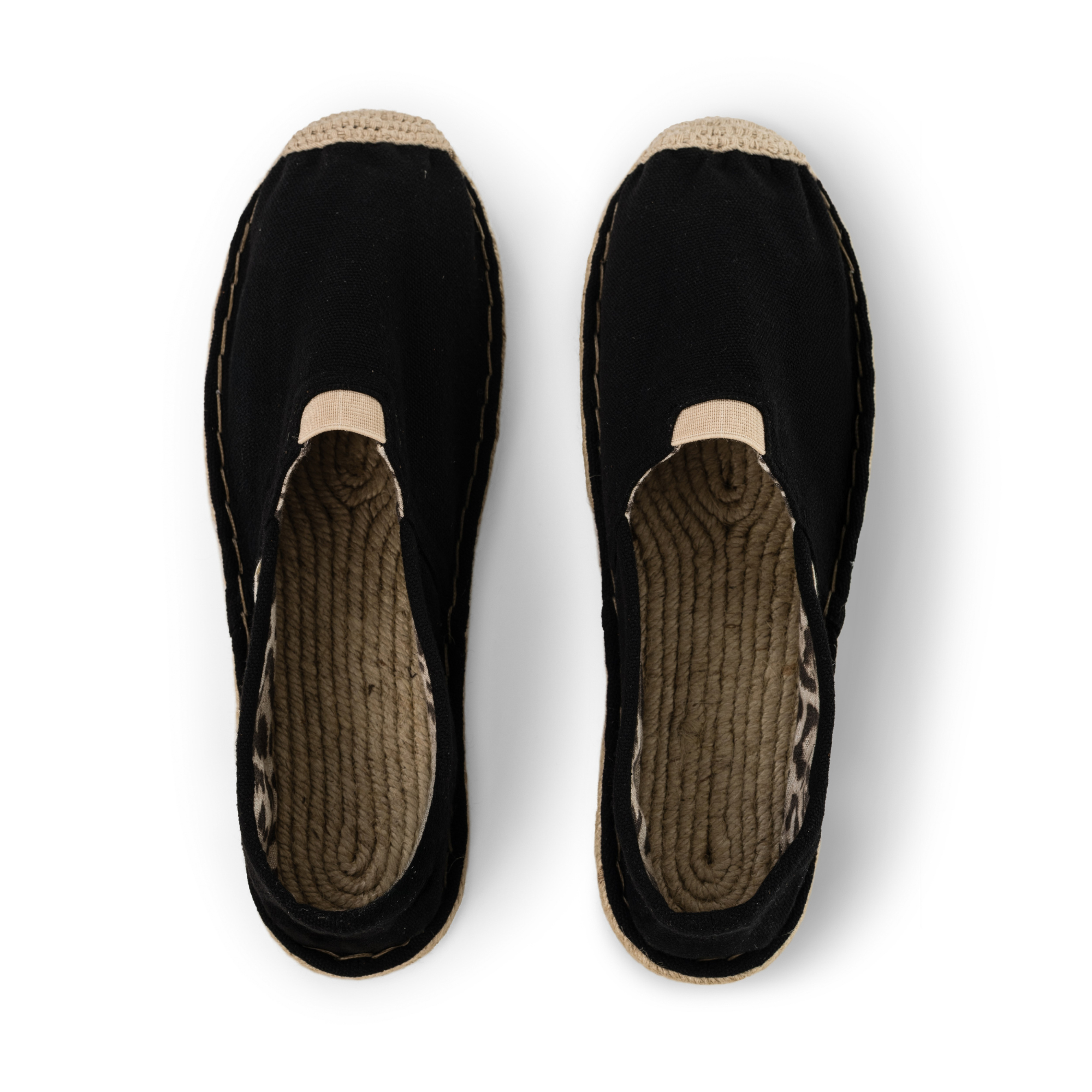 Pair of black espadrilles for women with jute sole on a white background