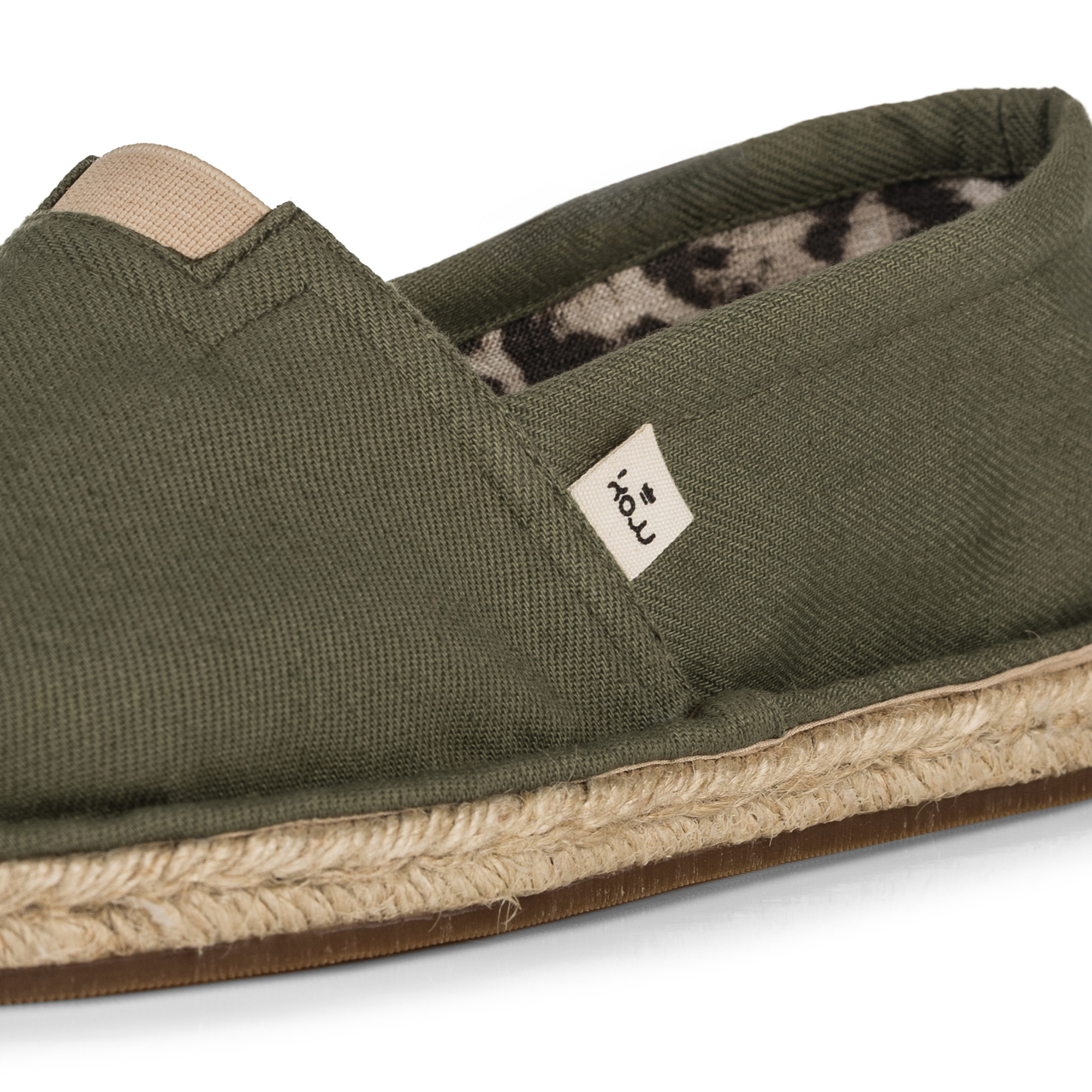 Olive green espadrille shoe with jute sole on a white background