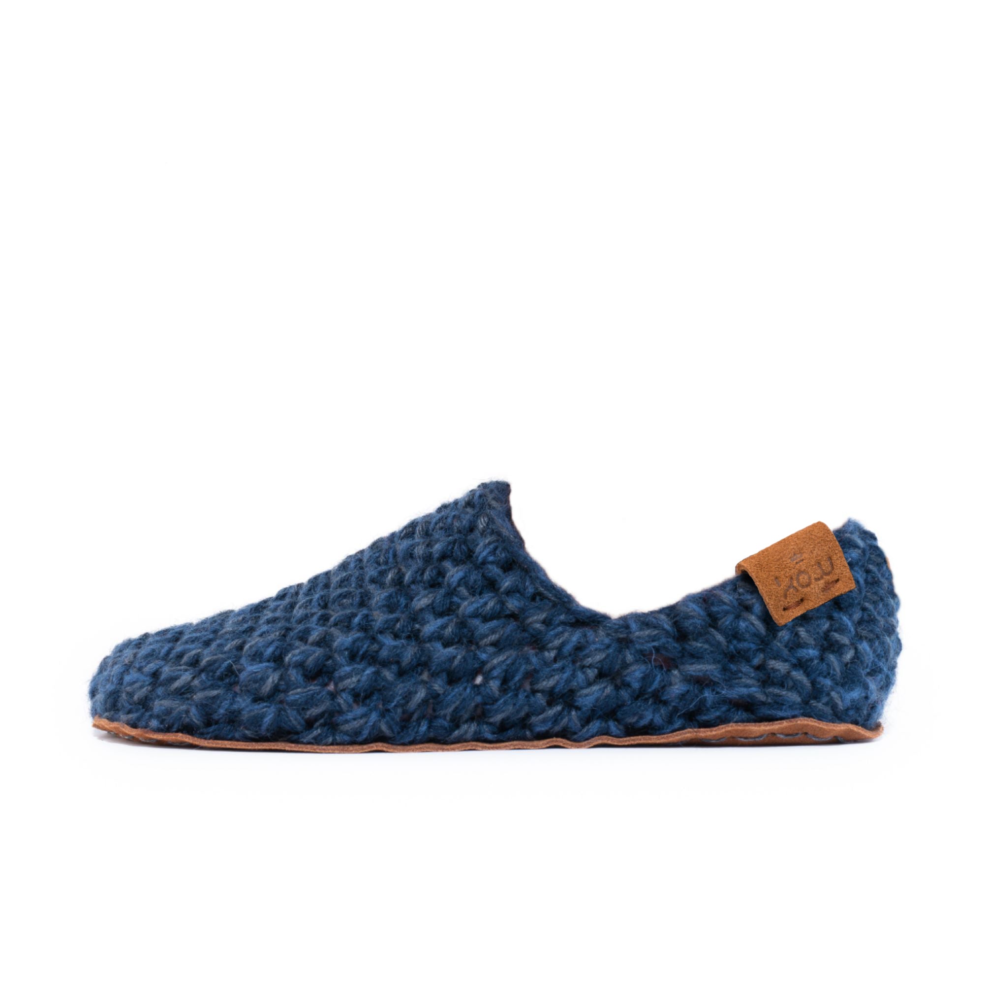 Blue crocheted slipper with leather sole on a white background