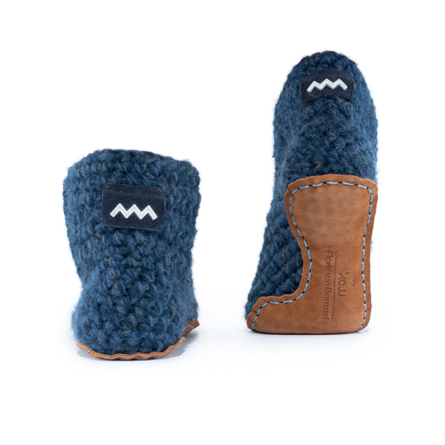 Floris x KOW slippers. A pair of midnight blue crocheted slippers with leather soles on a white background. Back view.
