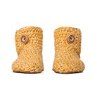 Floris x KOW slippers. A pair of Butterscotch yellow knit slippers with leather soles on a white background. Front view