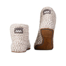 Floris x KOW slippers. A pair of chai beige crocheted slippers with leather soles on a white background. Back view.