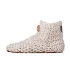 Floris x KOW slippers. A pair of chai beige crocheted slippers with leather soles on a white background. Side view.