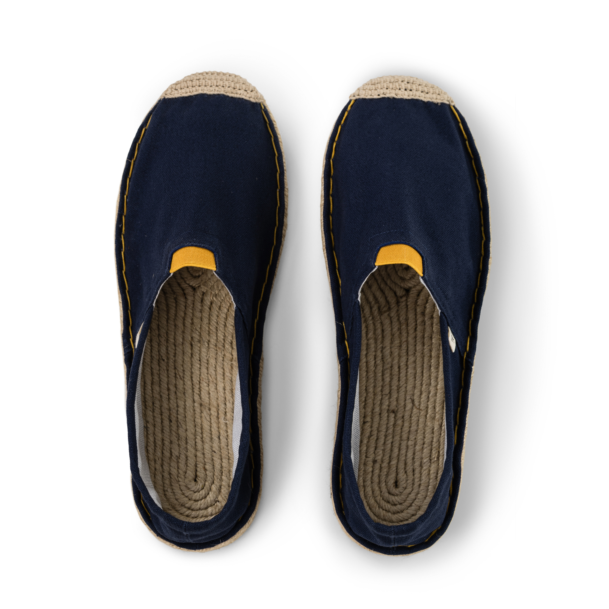 Pair of navy blue espadrilles with jute sole on a white background