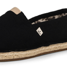 Close up of a black espadrille shoe with jute rope sole on a white background