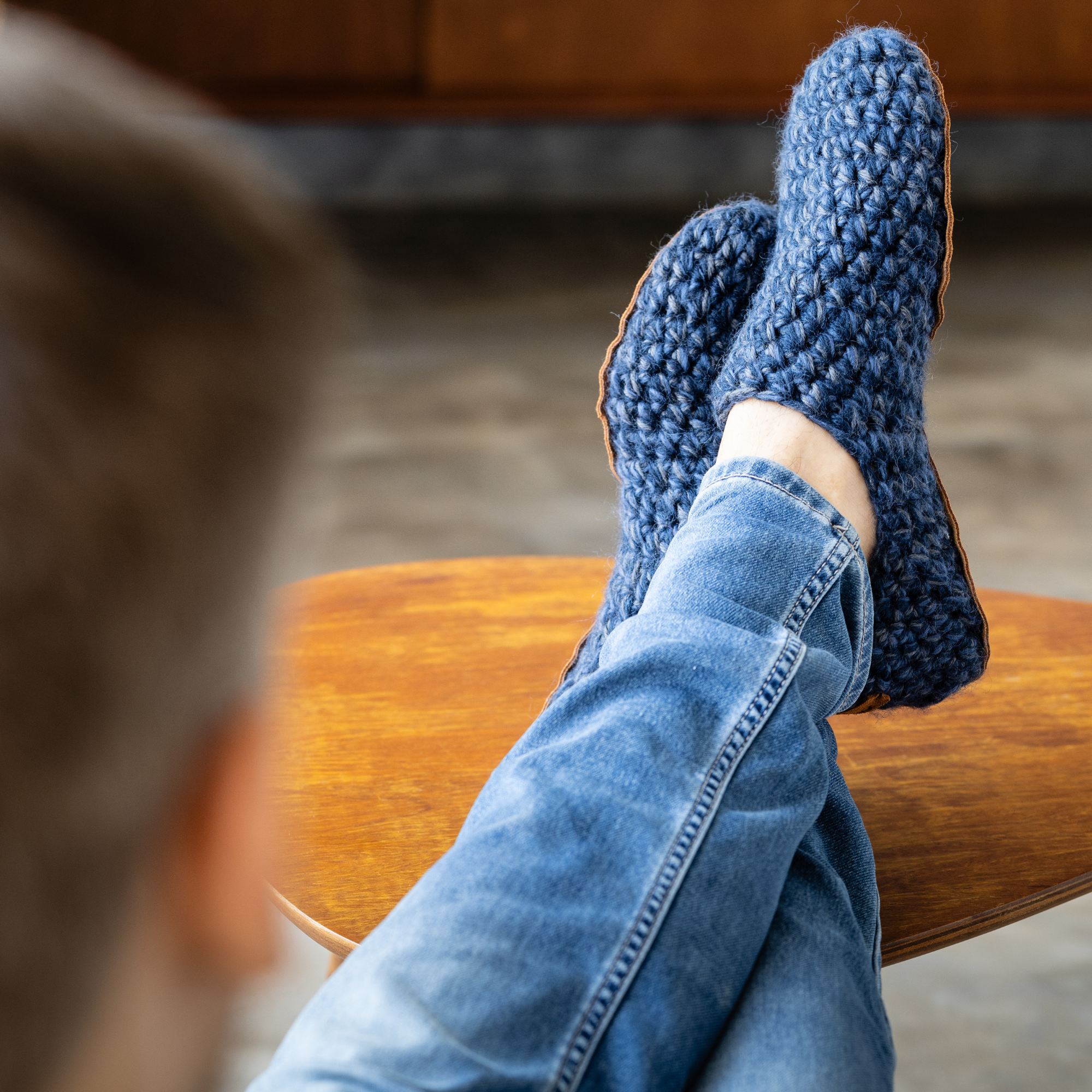 Person wearing blue crocheted wool slippers by Kingdom of Wow_video