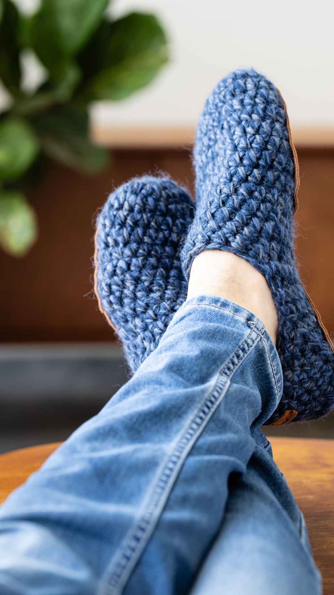 Person wearing blue crocheted wool slippers by Kingdom of Wow_video