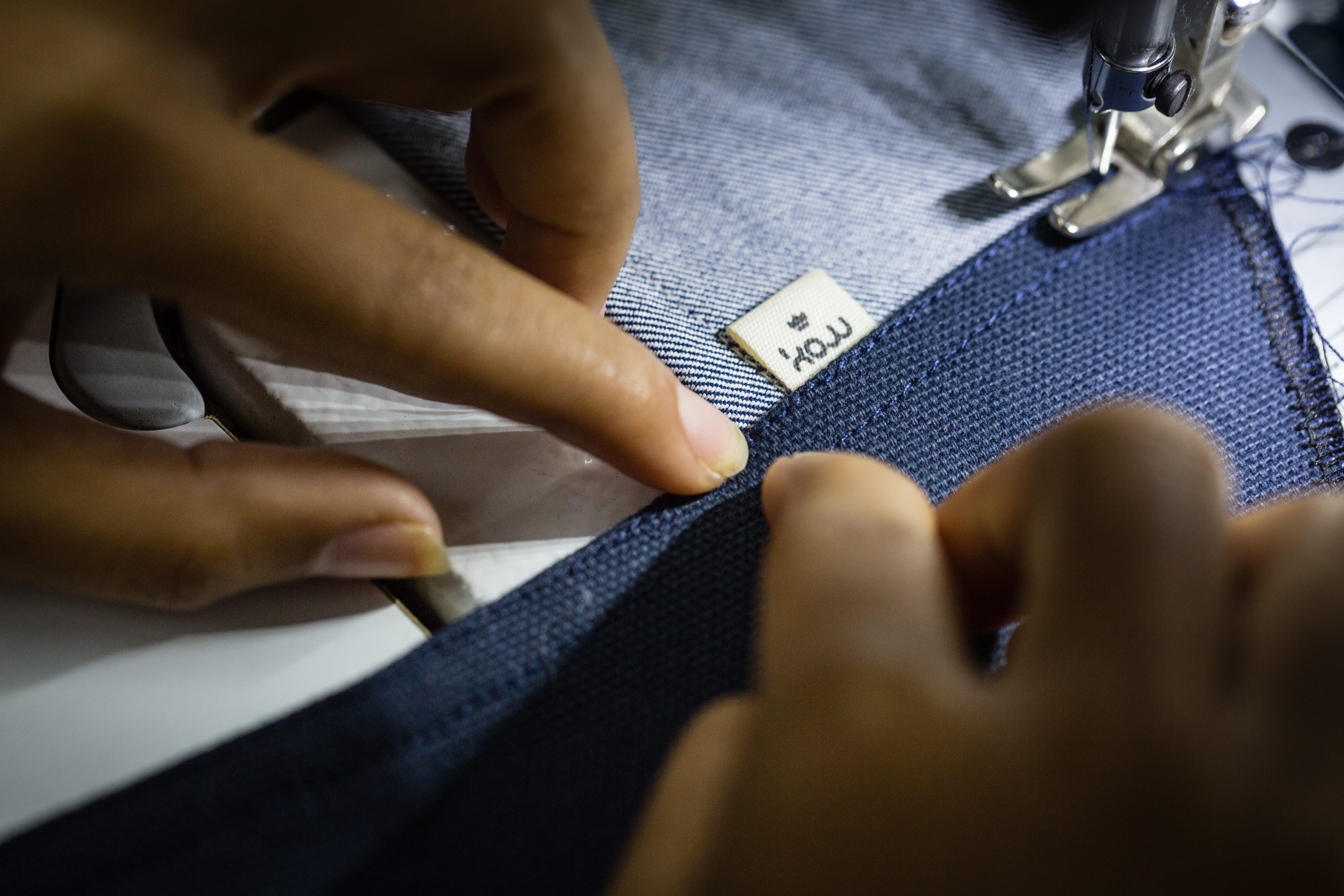 Close up of seamstress sewing espadrilles