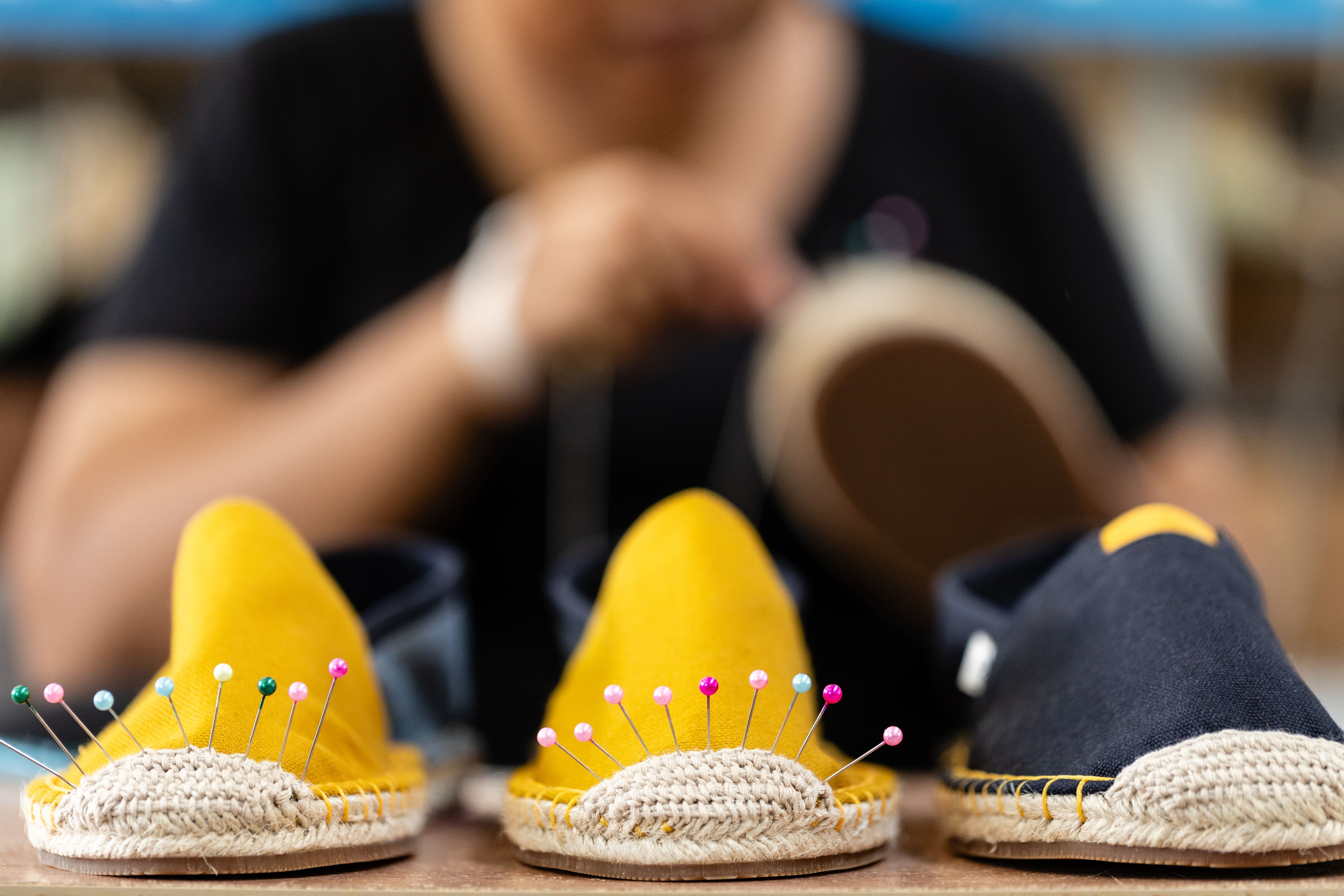 Close up of 3 espadrilles lined up during production