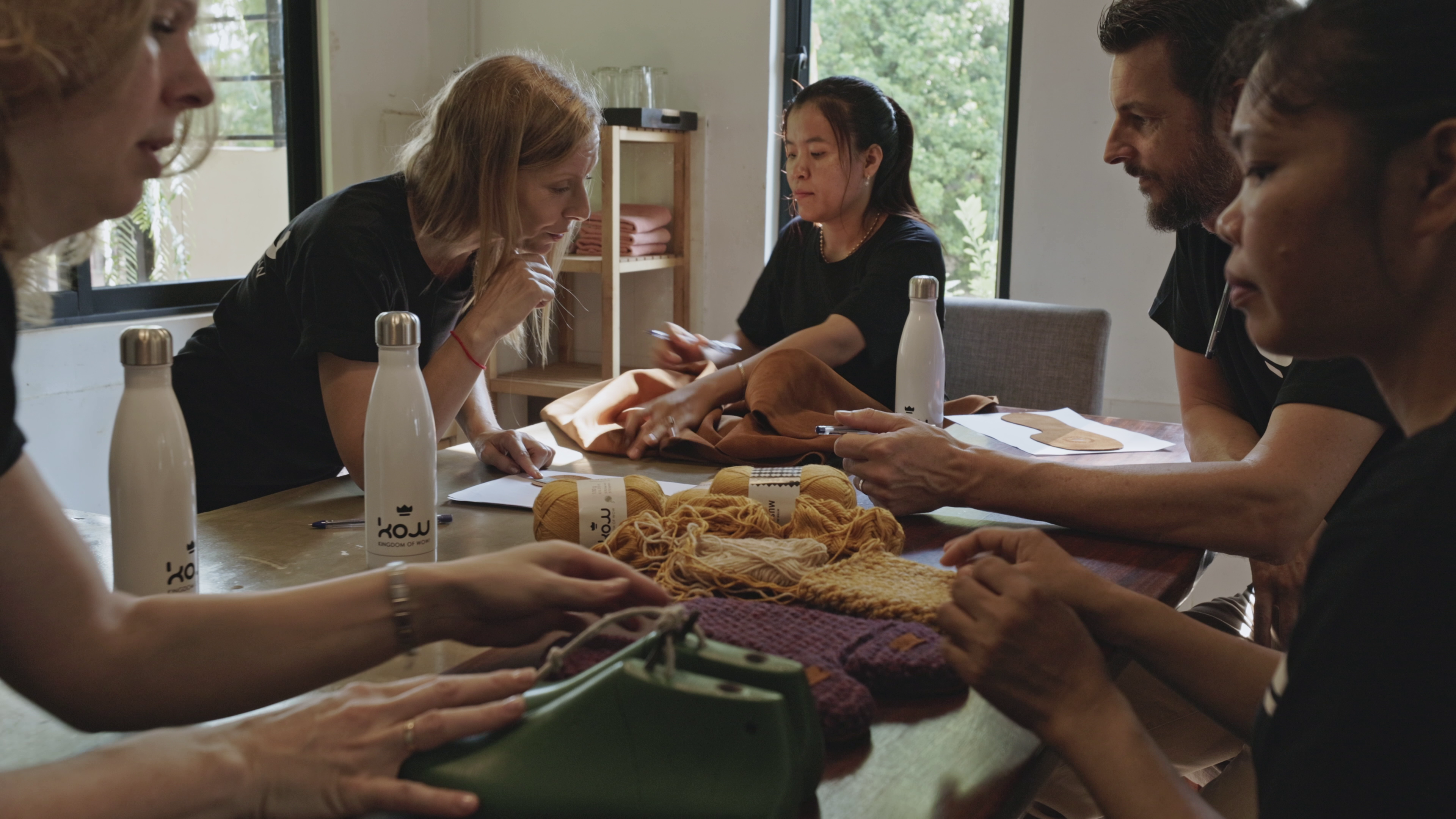 The Kingdom of wow team discussing new designs over a table